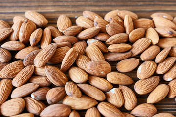 Almond nuts on wooden background. Healthy food. Close up.