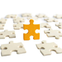 Vibrant yellow puzzle piece stands out against transparent background filled with scattered white puzzle pieces, symbolizing uniqueness