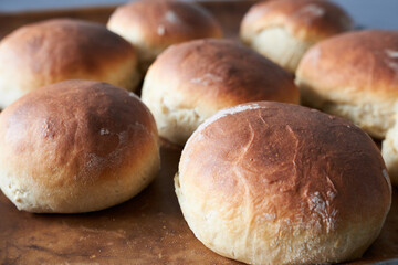 Bread buns on a baking sheet. Selective focus.