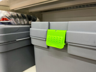 plastic tool box with green plastic handle on shelf in the supermarket