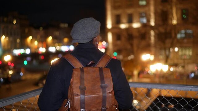 Young man admiring the parisian cityscape at night