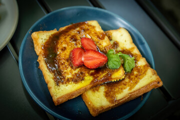 Sweet French Toast with Strawberry and Mint on Dark Blue Plate