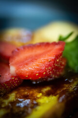 Extreme Close-up of French Toast with Syrup and Fresh Strawberry Slices