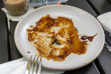 Dirty Plate with Leftover Sweet Sauce Swarming with Ants