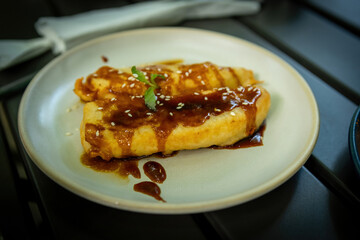 Traditional Indonesian Pisang Goreng with Caramel Sauce and Sesame Seeds