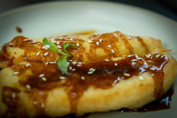 Traditional Indonesian Pisang Goreng with Caramel Sauce and Sesame Seeds