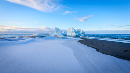 Snowy Arctic beach with majestic icebergs in the cold ocean under a blue sky.