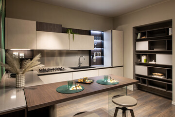 Modern kitchen interior with wooden dining table and breakfast setting