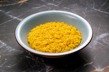 Italian saffron risotto from Lombardy serving traditional food