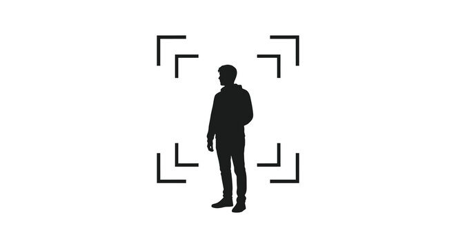 A solitary figure stands centered framed by square brackets a striking visual silhouette