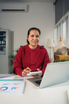 Startup small business entrepreneur or freelance using a laptop with box, checking orders from customers, matron runs an e-commerce business on websites and social media. 