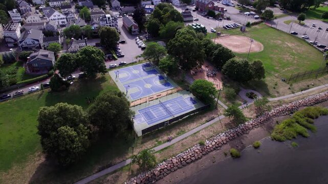 Two basketball courts and a tennis court are seen in the Cashman public park along the Merrimack River in Newburyport, Massachusetts.