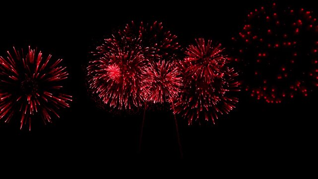 Series of red fireworks exploding simultaneously in a grand finale. Perfect for New Year, 4th of July, or celebration backgrounds