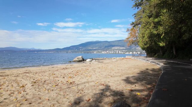 Gimbal moving shot walking along the seawall by Third Beach at Stanley Park in Vancouver, British Columbia, Canada. 4K at 30 FPS