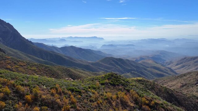 Aerial view of Four Peaks wilderness shows the undulating landscape with varied textures and colors under a blue sky, Apache Junction, Arizona, United States.