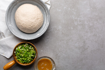 overhead view of mise en place of ingredients for making scallion pancakes, ingredients for making chinese scallion pancakes