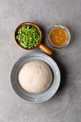 overhead view of mise en place of ingredients for making scallion pancakes, ingredients for making chinese scallion pancakes