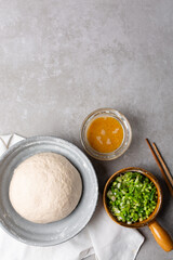 overhead view of mise en place of ingredients for making scallion pancakes, ingredients for making chinese scallion pancakes