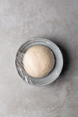 Overhead view of scallion pancake dough resting in a bowl, top view of cong you bing dough resting, process of making scallion pancakes