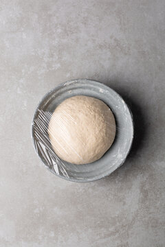 Overhead view of scallion pancake dough resting in a bowl, top view of cong you bing dough resting, process of making scallion pancakes