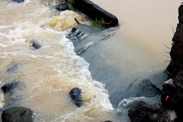 Turbulent River Water Flowing Over Rocks After Rain