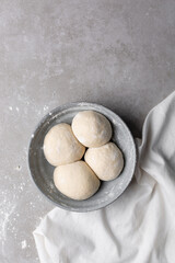 Overhead view of divided chinese scallion pancake dough, top view of chinese pancake dough, process of making cong you bing