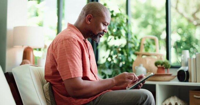 Reading, relax or black man in home with tablet, personal development blog or search online for self help ebook. Mature, browsing internet or person with tech for learning, goal setting forum or app