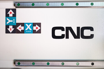 Stickers and rails on a machine indicating the X and Y axis