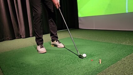 Golf practice session at indoor facility with focus on swing and putting skills