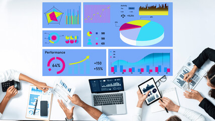 A diverse business team collaborates on data analysis using charts and digital devices in a modern office. The colorful graphics highlight performance metrics and insights. Axiom