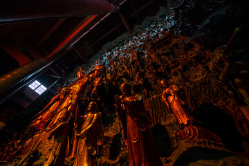 Hangzhou, China, 2 January 2025: Golden and stone statues in the temple