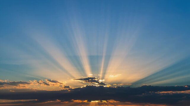 Radiating broad dark cloud bank sending crepuscular rays over sea horizon, with sun peeking behind