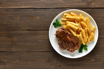 Roasted pork steaks and french fries