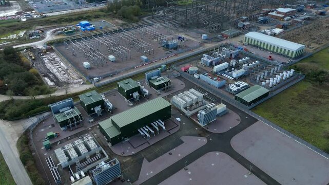 Aerial view of an industrial area with buildings, electrical equipment, and construction, contrasting the green of the surrounding vegetation, Wisbech, England, United Kingdom.