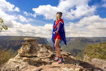 Hiker Australia Day cliff top Blue Mountains with flag draped around body