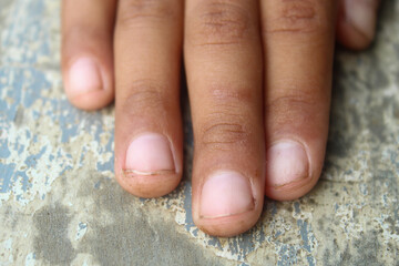 Close up detail of boy's finger with brown skin tone