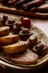 Fried potatoes with mushrooms and cherry tomatoes on a white background.