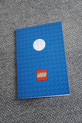 Obraz premium Lego-themed notebook on a gray carpet background, perfect for creative writing