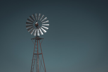 Windpump against a dark, night sky in El Paso, Texas, USA farmland