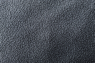 A dark gray fleece fabric with a soft, fuzzy surface. The dense, repeating fiber pattern creates a warm, cozy look. © Hendri