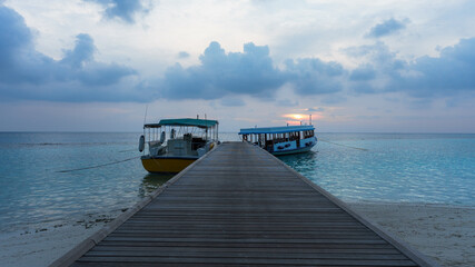 Maldives. Jetty with diving boats during sunset 