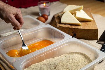Bread the cheese with eggs and breadcrumbs