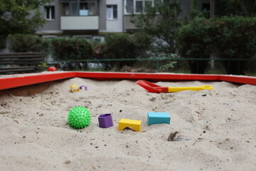 Sandbox with various outdoor toys. Sandbox for children's games. Summer concept.