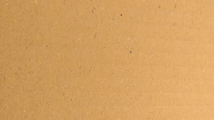 a brown cardboard surface with a characteristic texture. Kraft paper texture background material.