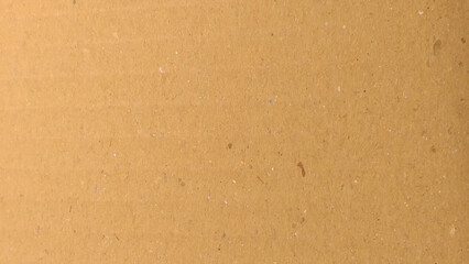 a brown cardboard surface with a characteristic texture. The brown tone is warm and natural, reflecting a simple and eco-friendly material.
