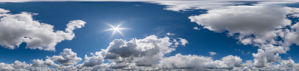 Seamless hdri panorama 360 degrees angle view blue sky with beautiful fluffy cumulus clouds with zenith for use in 3d graphics or game development as sky dome or edit drone shot