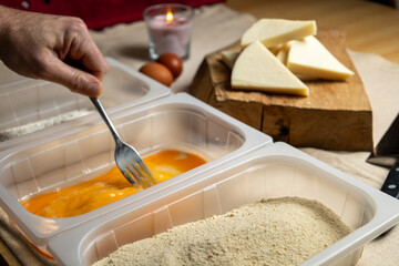 Bread the cheese with eggs and breadcrumbs