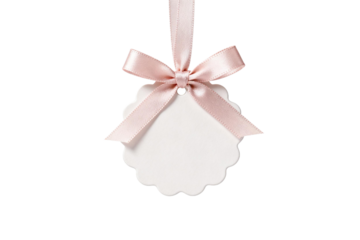 Delicate pink ribbon tied around a scalloped white tag