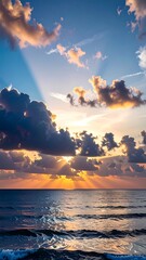 Sunrise over the ocean with dramatic clouds