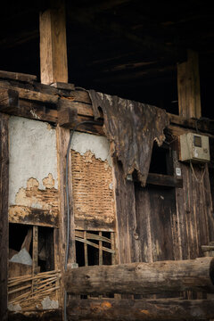 View of weathered wooden beams and crumbling brickwork tell a story of time in Tang Valley, Ogyencholing, Bumthang, Bhutan.